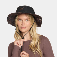 Woman wearing a black and leopard print hat on a white background