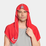 Man wearing a red hooded towel with a logo on a light gray background