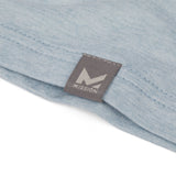 Close-up of a light blue fabric with a gray tag featuring the 'Mission' logo.