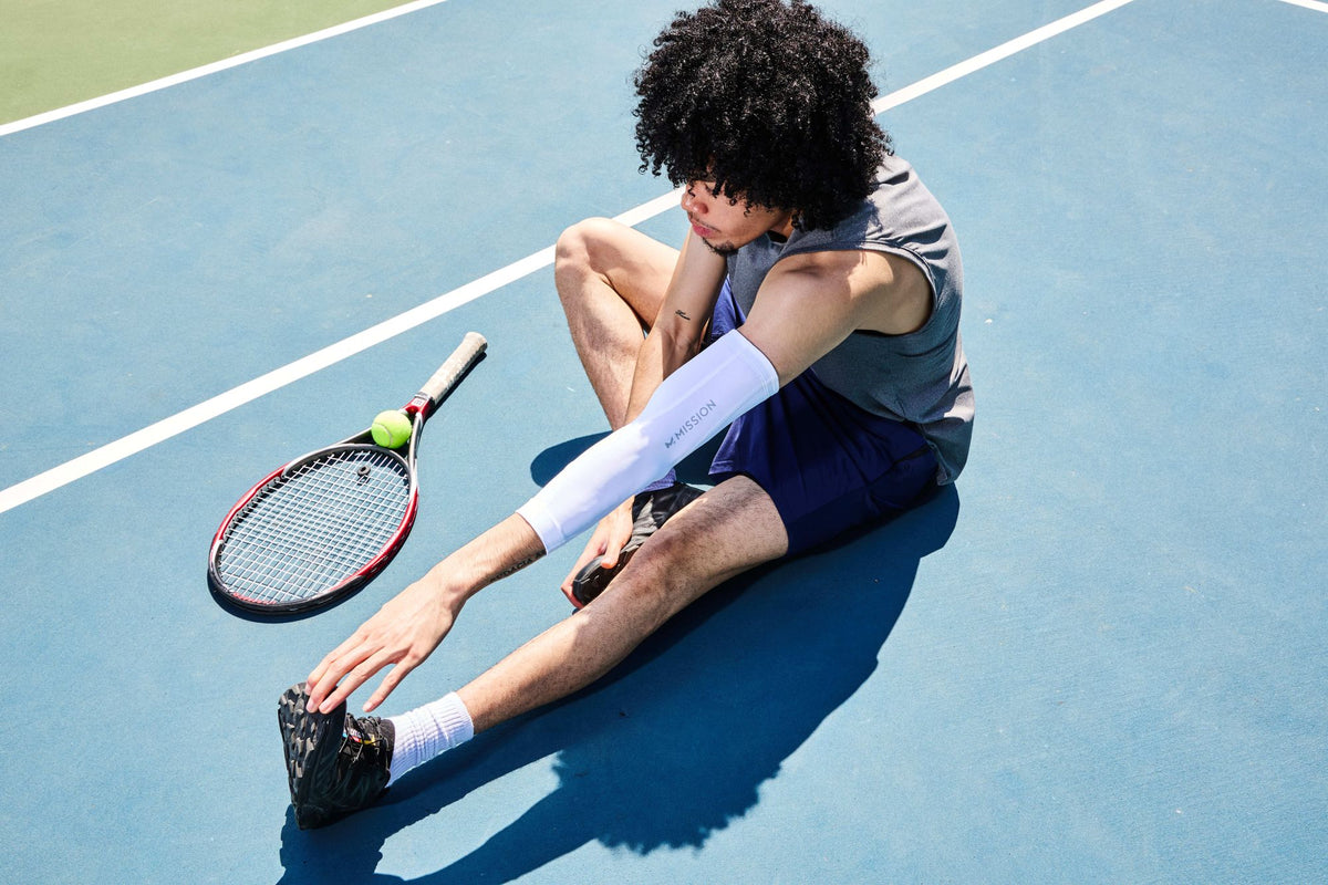 Tennis player stretching wearing a Mission Compression Sleeve
