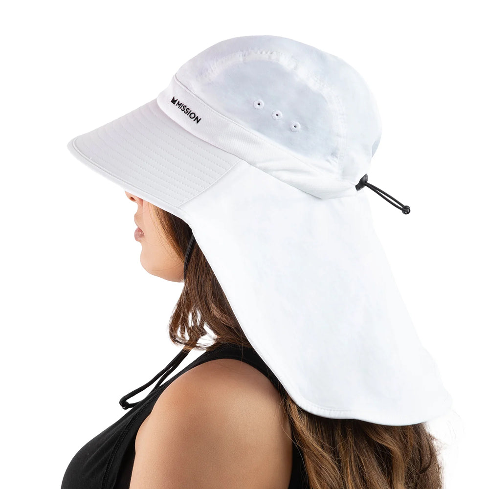 A woman shown in side profile wearing a white sun hat with a wide brim and an attached neck flap. The hat has a small black logo reading 'MISSION' on the side and a black drawcord closure at the back of the neck.