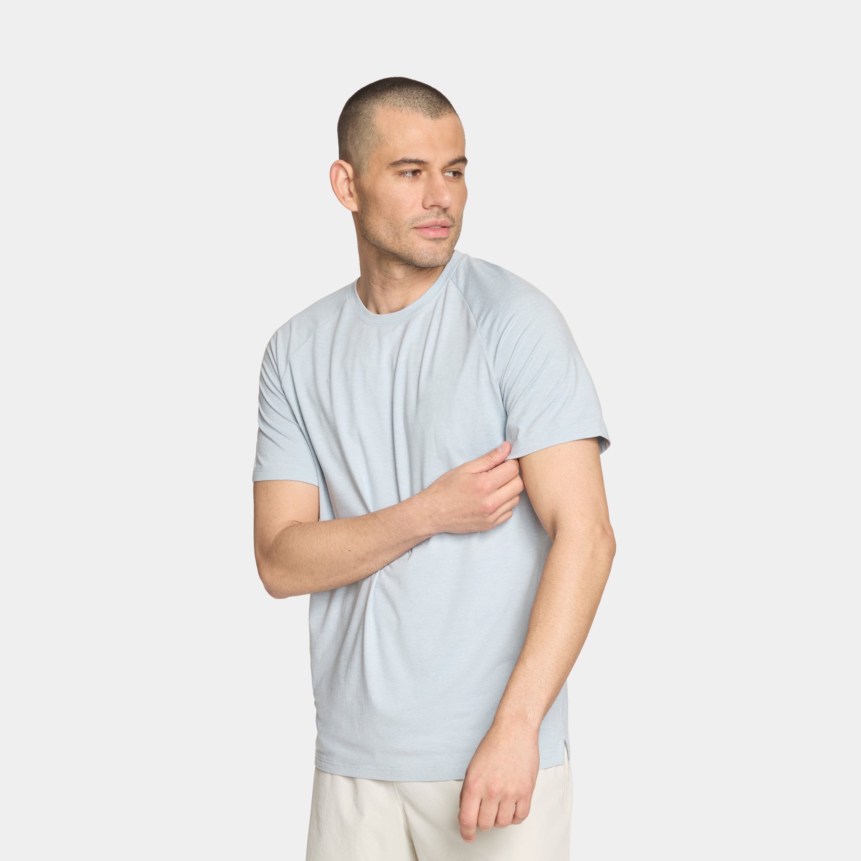 Man wearing a light gray t-shirt on a white background
