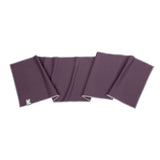 A dark purple yoga mat with a thin gray border, shown folded on a plain white background. A small white brand tag is visible in the bottom-left corner.